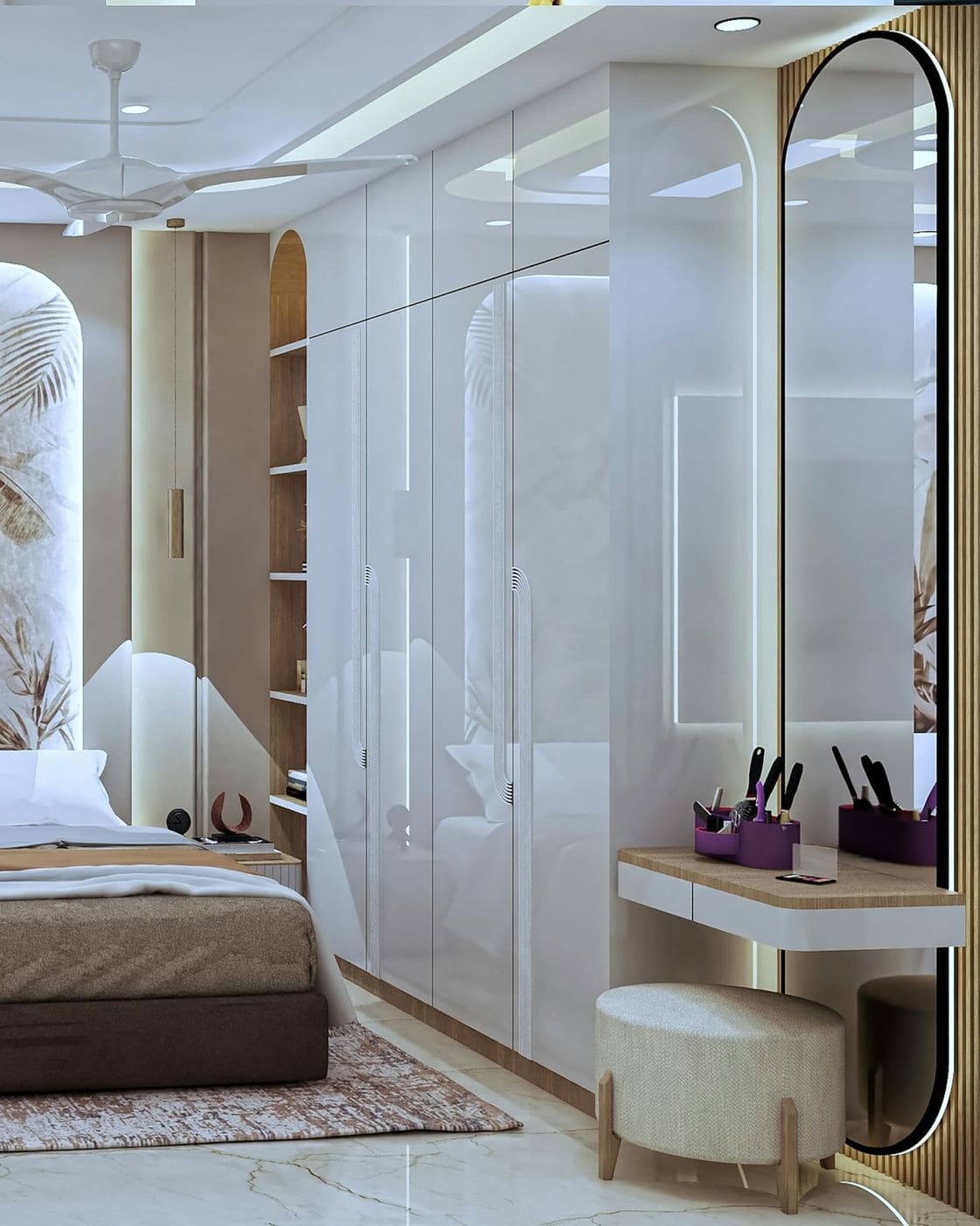 Glossy white wardrobe shutters with profile lighting beside an arched mirror and dressing table in a bedroom